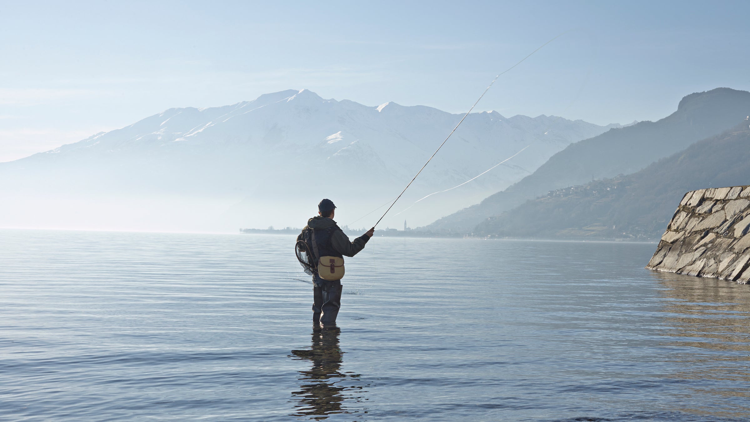man fly fishing in lake como