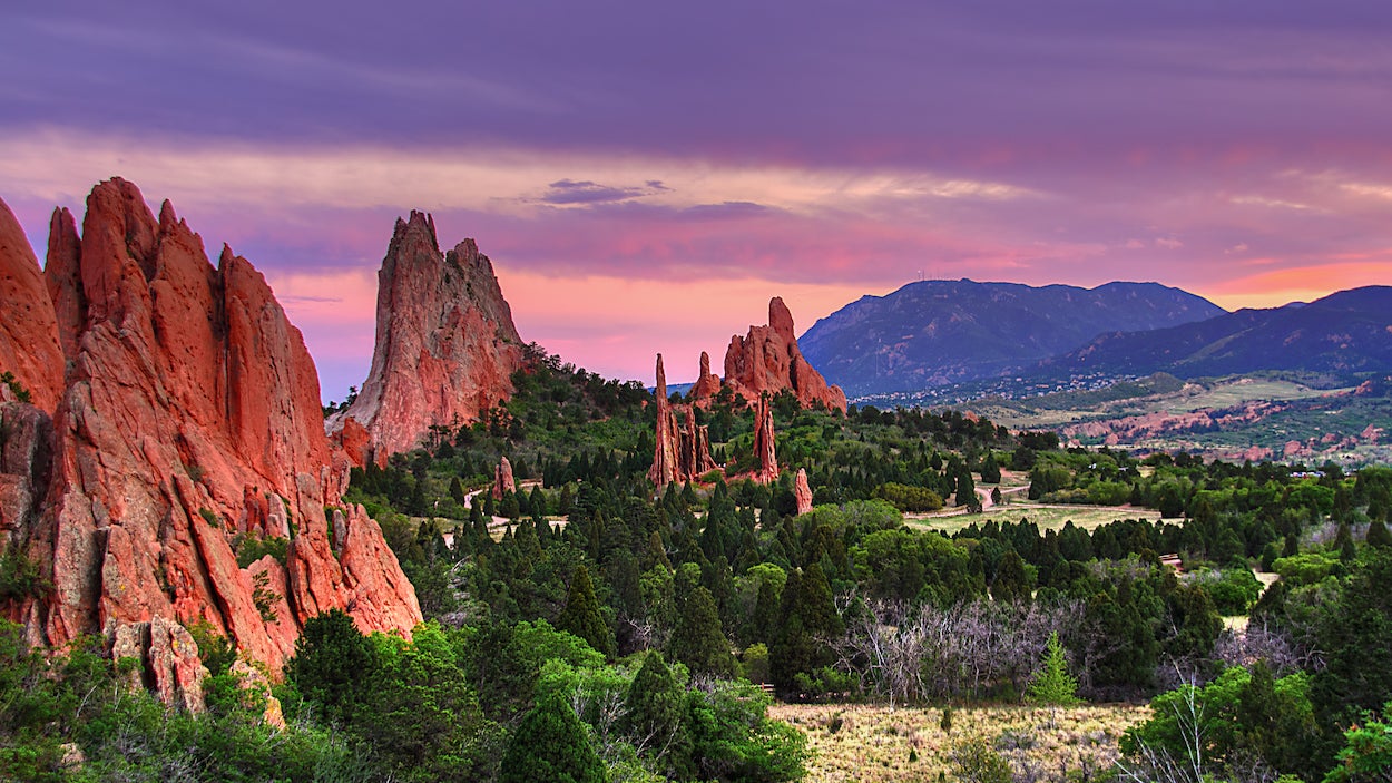 A lush purple sunset lights up the Garden of the Gods in Colorado.