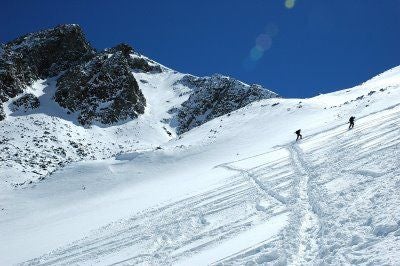 Hikers ascend the basin below Castle Peak None
