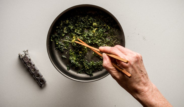 Eggs Benedict: Step 5 Immediately add the kale chips to the remaining water, heating and stirring for about 30 seconds, until they are fully reconstituted and warm.