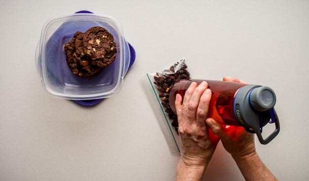 Cheesecake: Step 4 Prepare cookies and crumbs: Place one cookie in the empty sugar mixture bag, and using the bottom of a water bottle, carefully crush the cookie. Set…