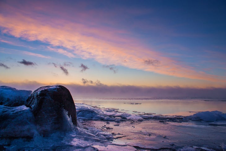 Lake Superior Sunrise To get this shot, Joshua Lais lay on top of ice-covered rocks holding his camera near the surface of Lake Superior. \