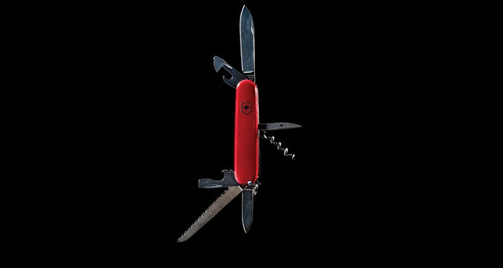swiss_army_knife_fullerton Red swiss army multitool on black background (Ben Fullerton)