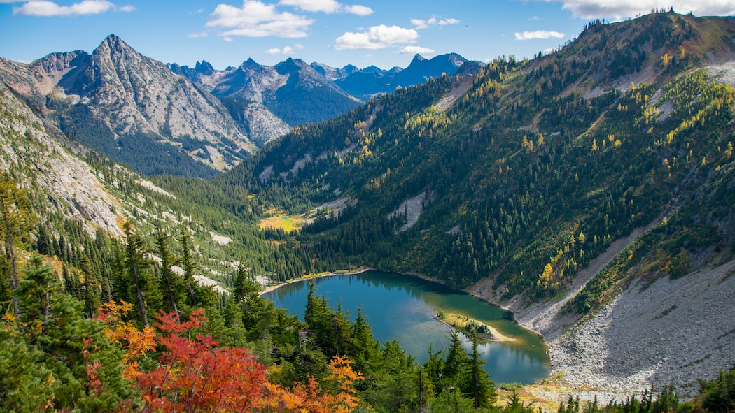 Looking down on beautiful Lake Ann surrounded by colorful fall foliage in Washington's North Cascades in autumn.
