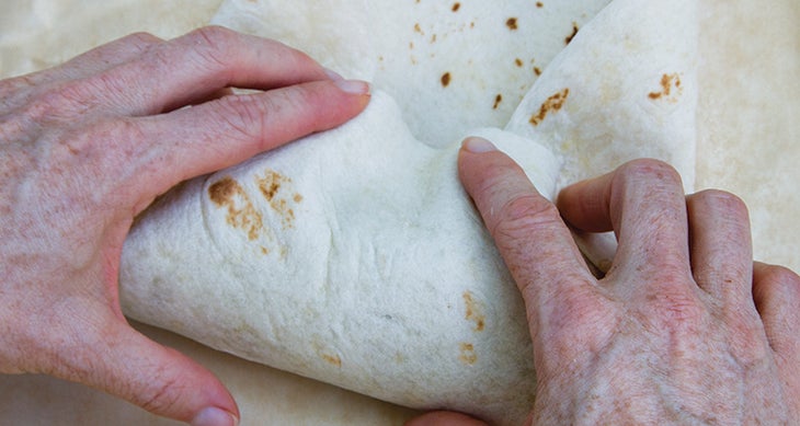 Fold the sides in more so that they don't extend pass the burrito. Photo by Jenny Jakubowski