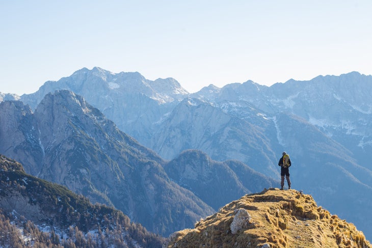 Alpinist enjoying the View over the mountains in the Alps