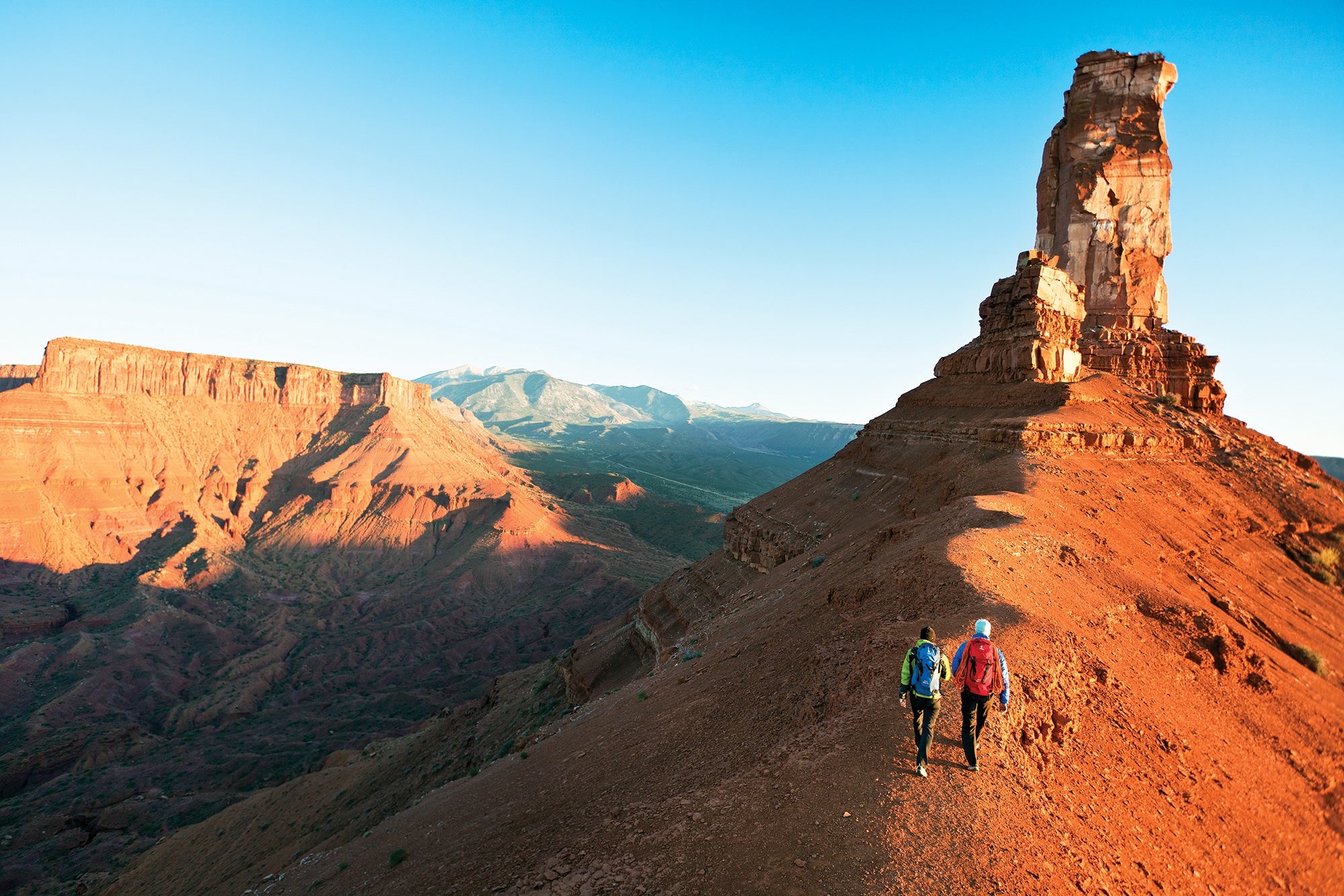 "Hikers on the saddle below Castleton Tower"