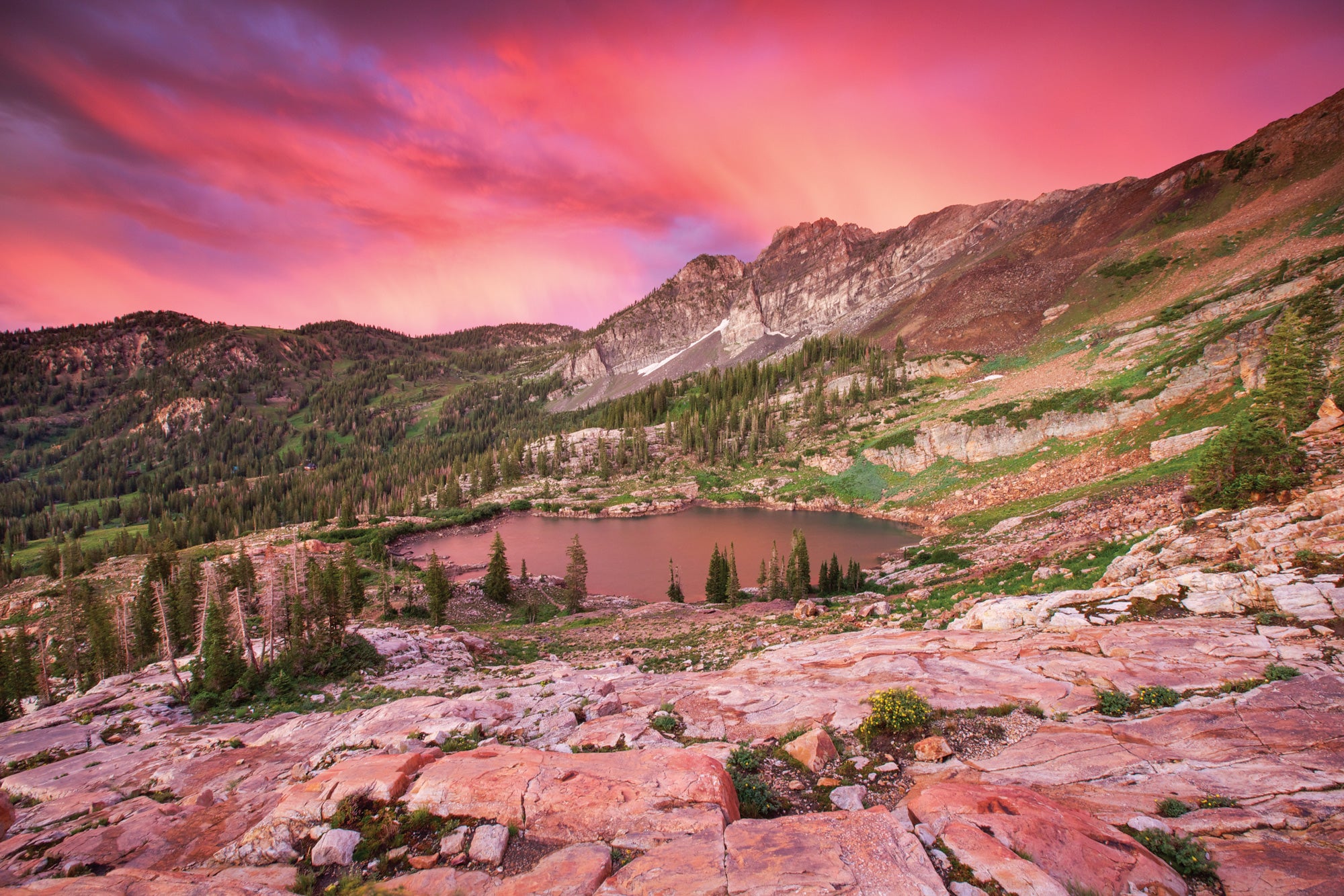 "Use leading lines—in this case, cracks in the rock and strips of grass—to draw the eye to the focal point of the image. Secret Lake, Wasatch…"