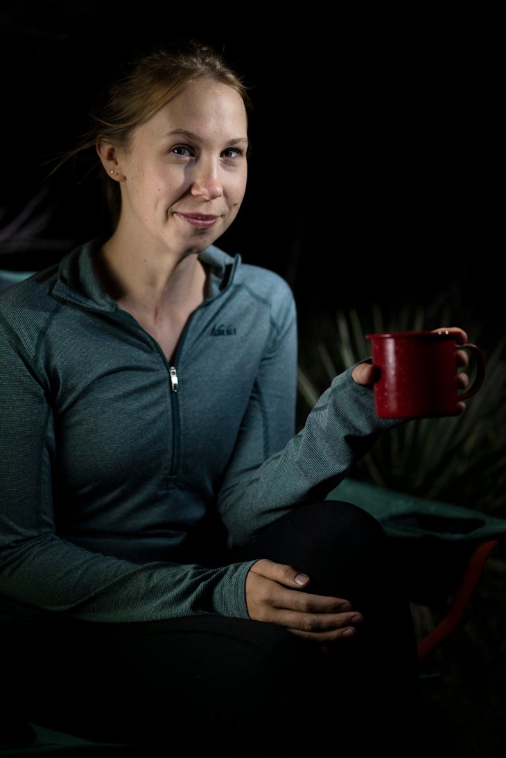 Petzl_strange_12_better photos prop Up close photo of woman holding camp mug at night.