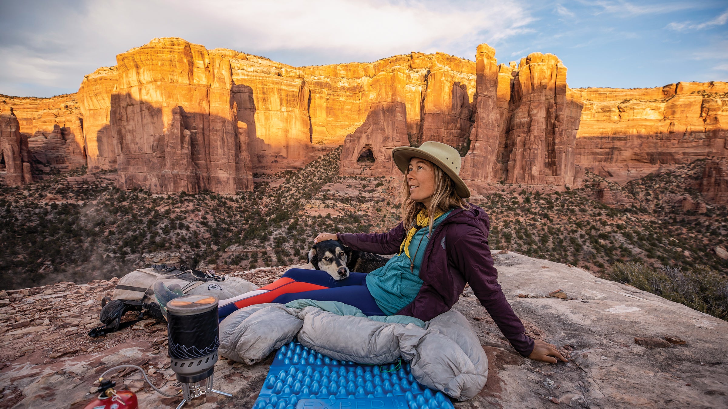 Hiker and dog with rocky utah canyon landscape