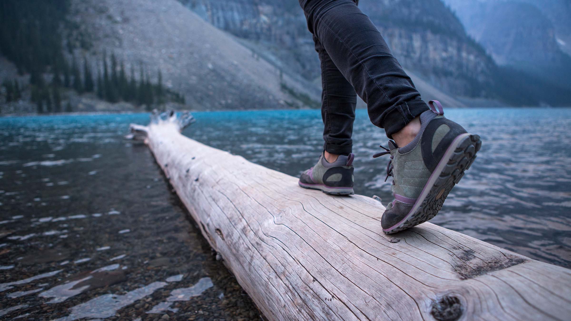 hiker walking on log