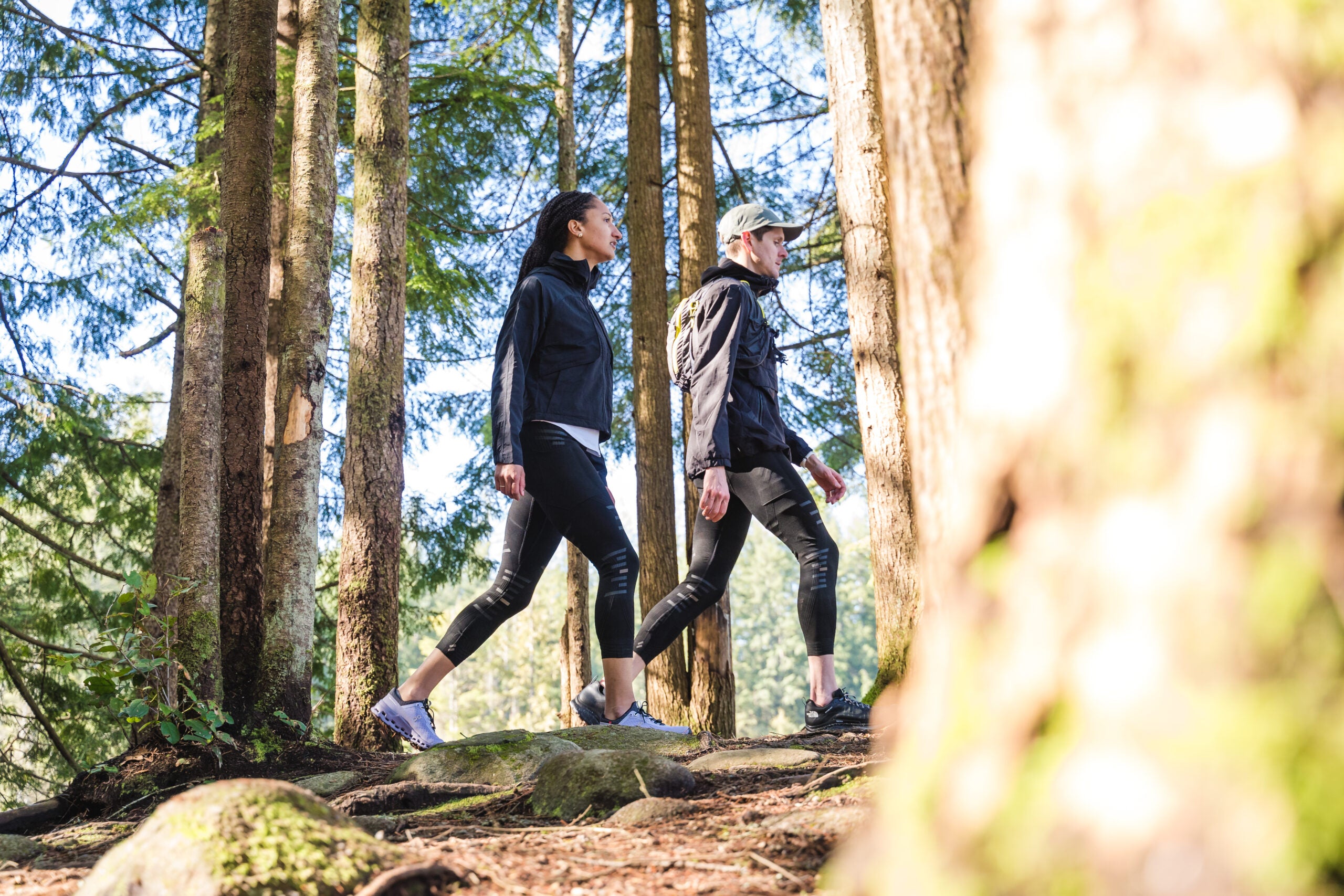 Hikers wearing Stoko tights while hiking a forest trail