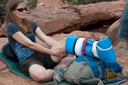 woman sitting with ankle brace, which is one of the best way to treat a sprained ankle