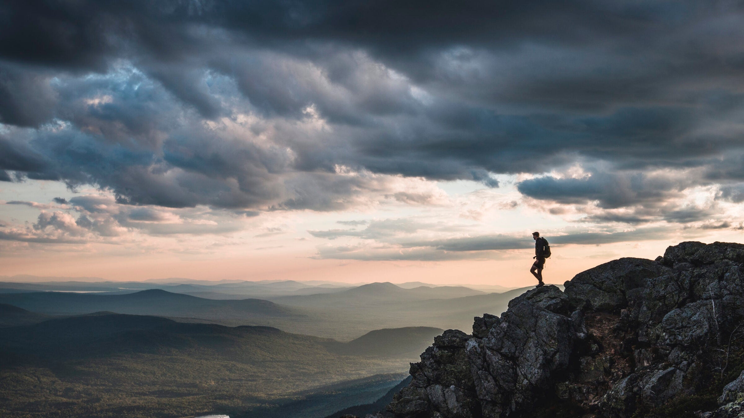 Lone hiker on mountain summit
