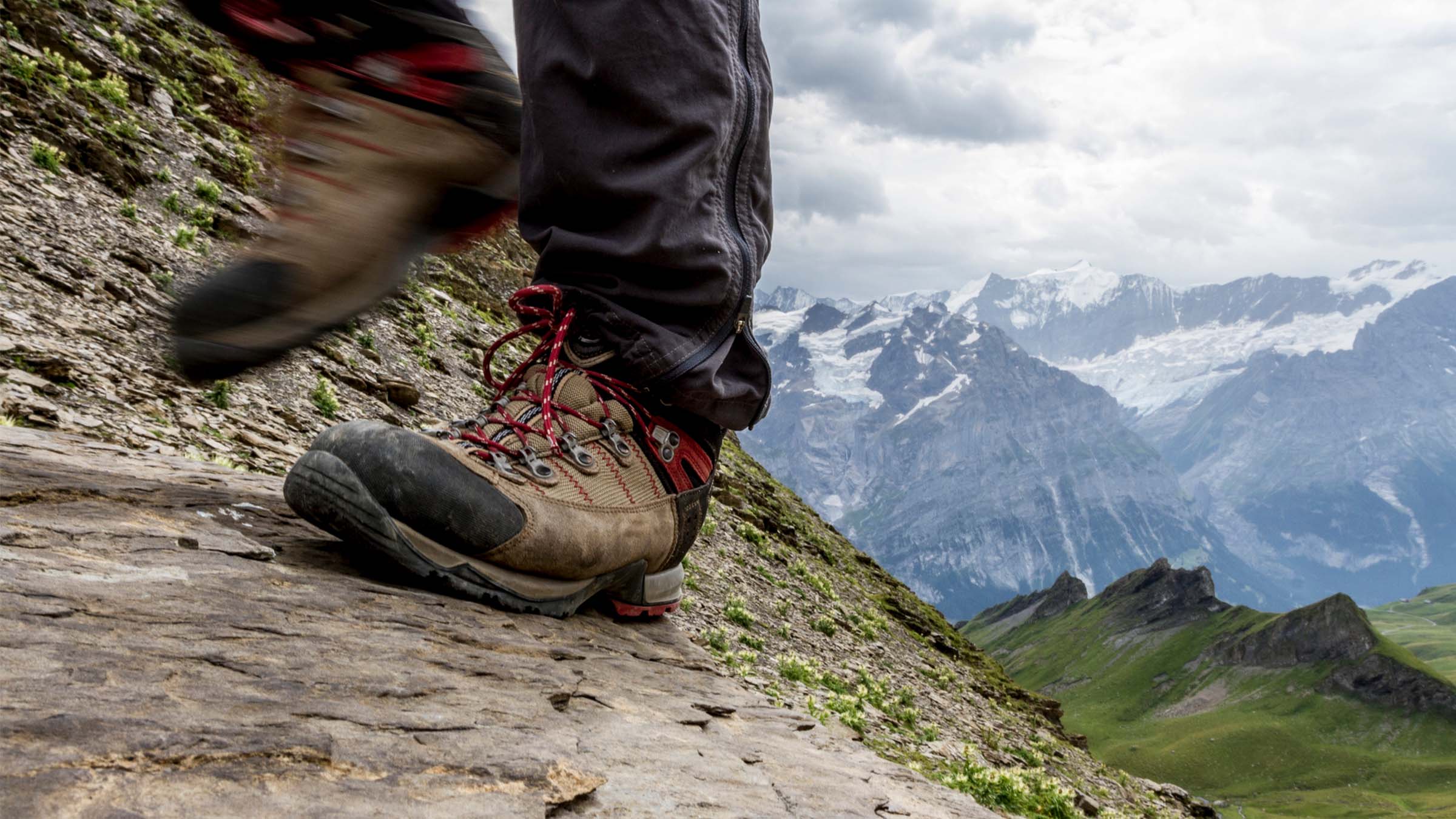 Hiker's feet in boots on the trail, sore feet concept
