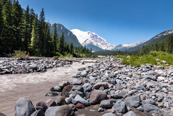 The peak of Mount Rainier in the Mount Rainier National Park behind the Ohanapecosh River, Washington