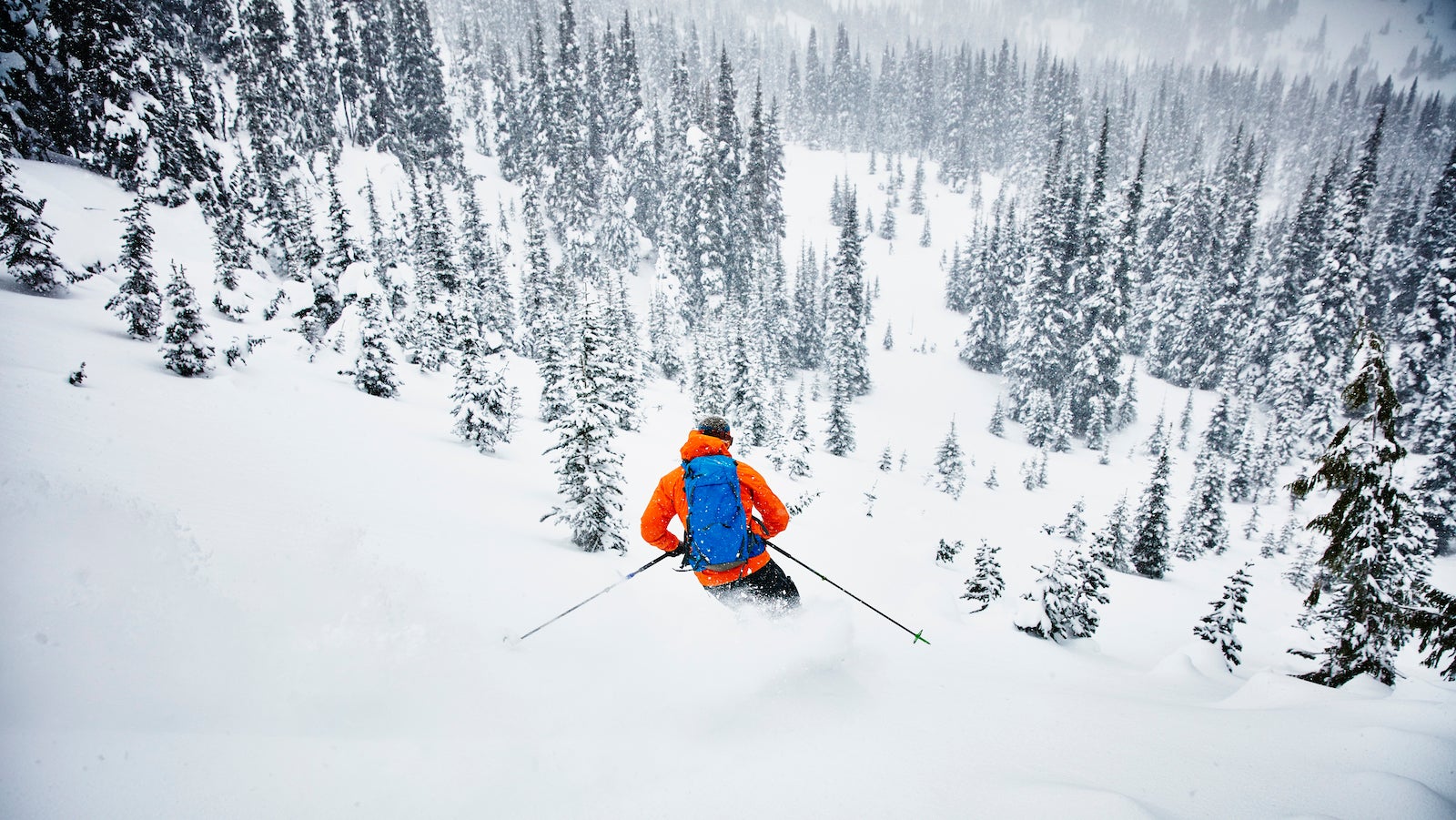 backcountry skier moves through fresh snow