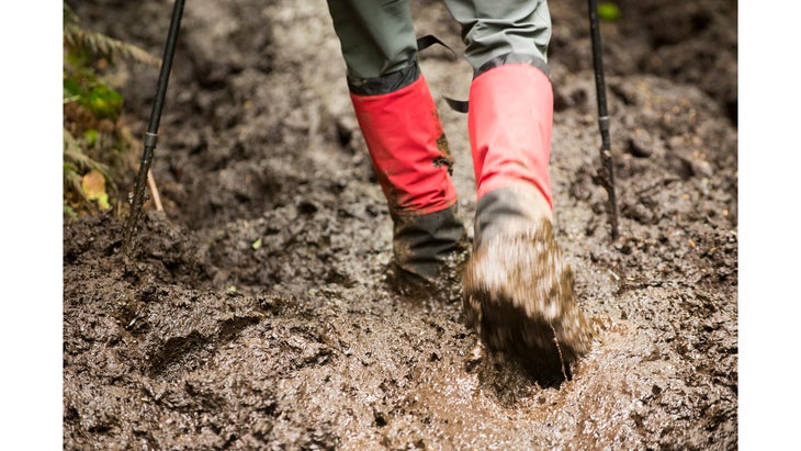 A hiker walks through mud in British Columbia.