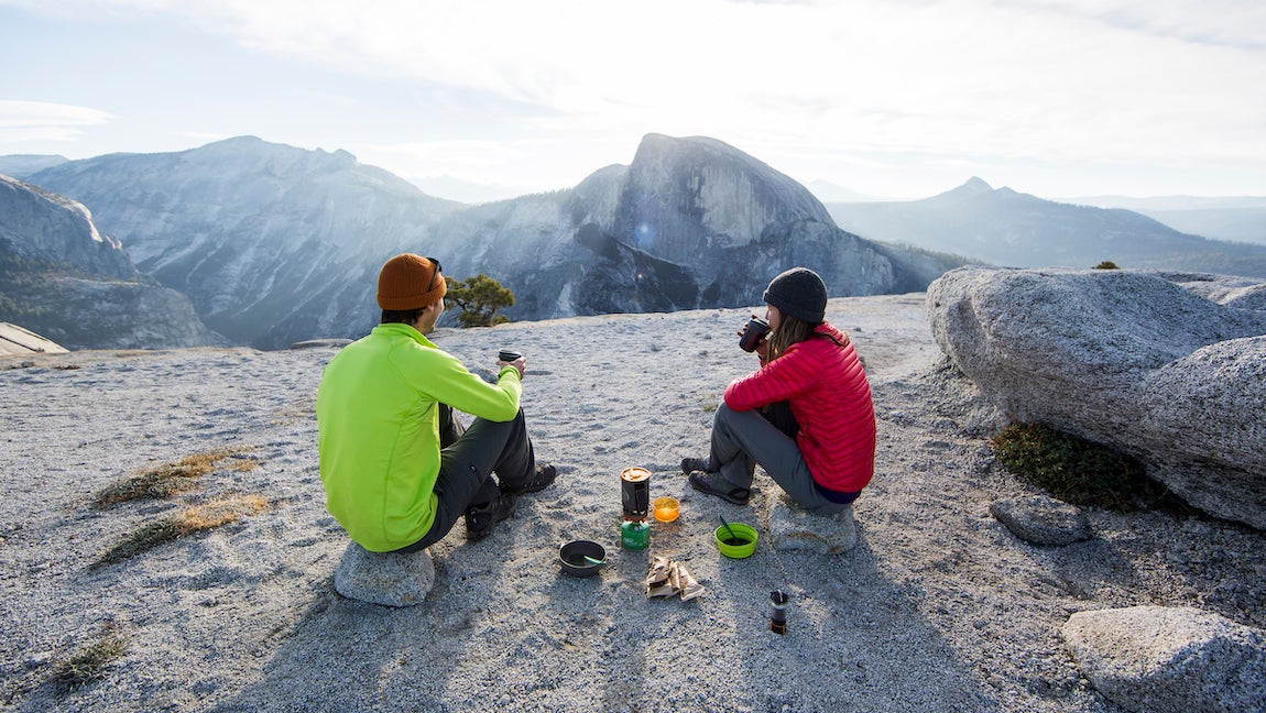 A couple enjoying breakfast with Half Dome in the distance.