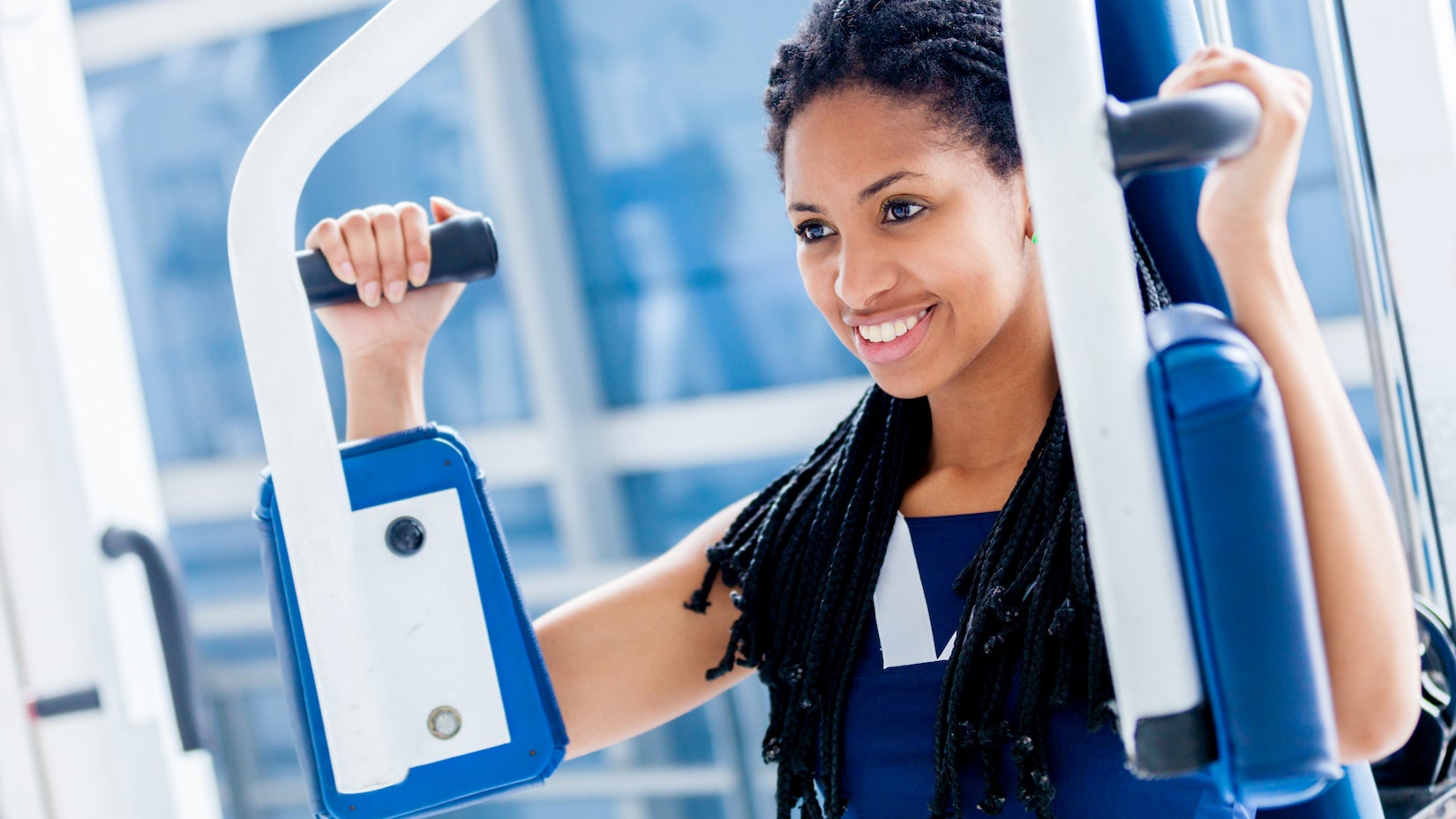 woman on pec machine at the gym