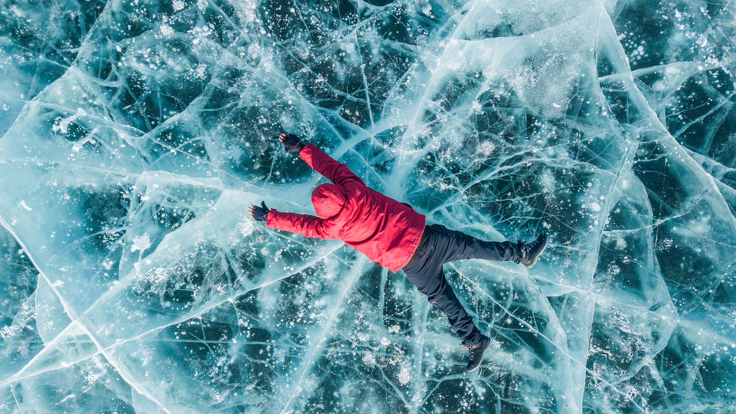 person lying on frozen lake