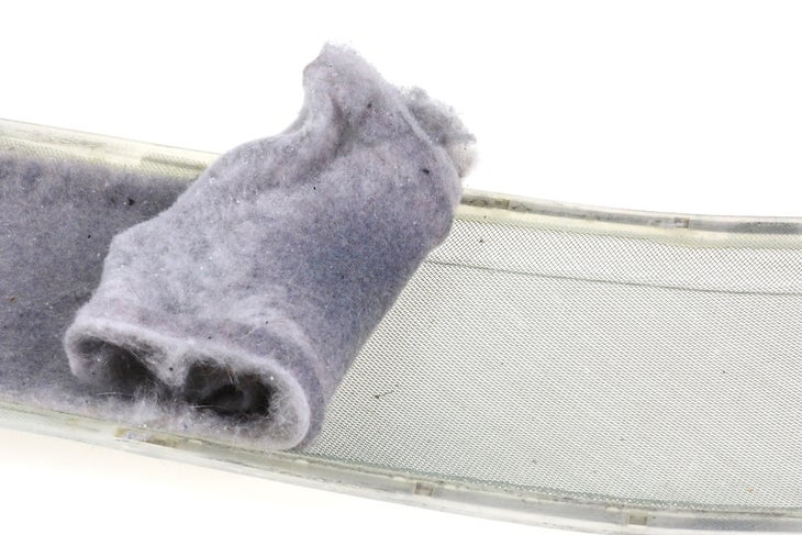 Fabric lint buildup on a clothes dryer clean out