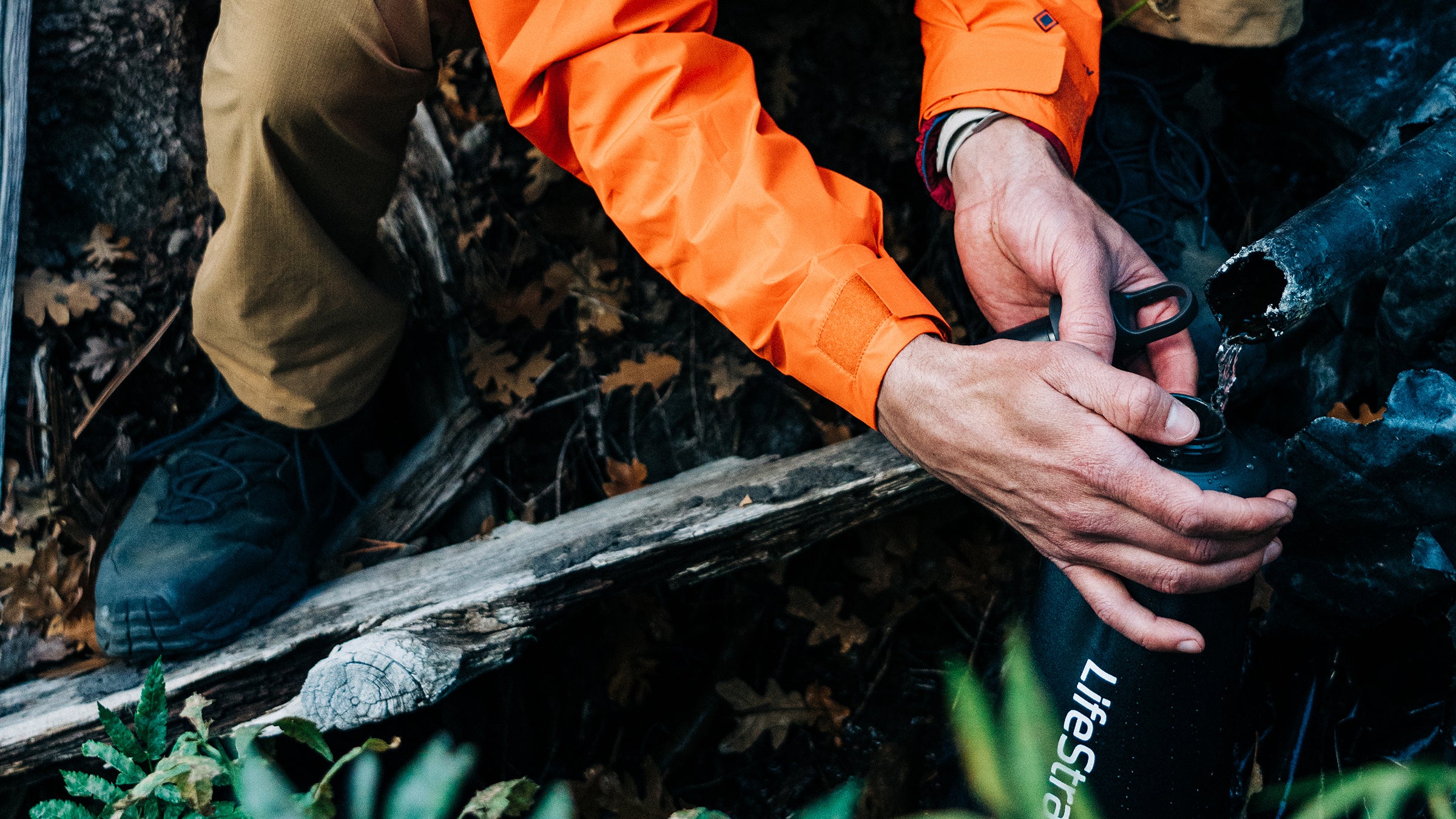 Hiker using a LifeStraw water filter