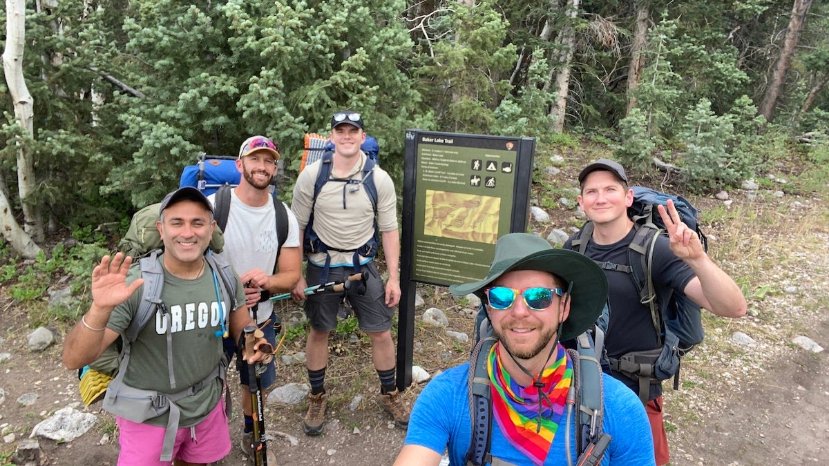 five male hikers taking a selfie