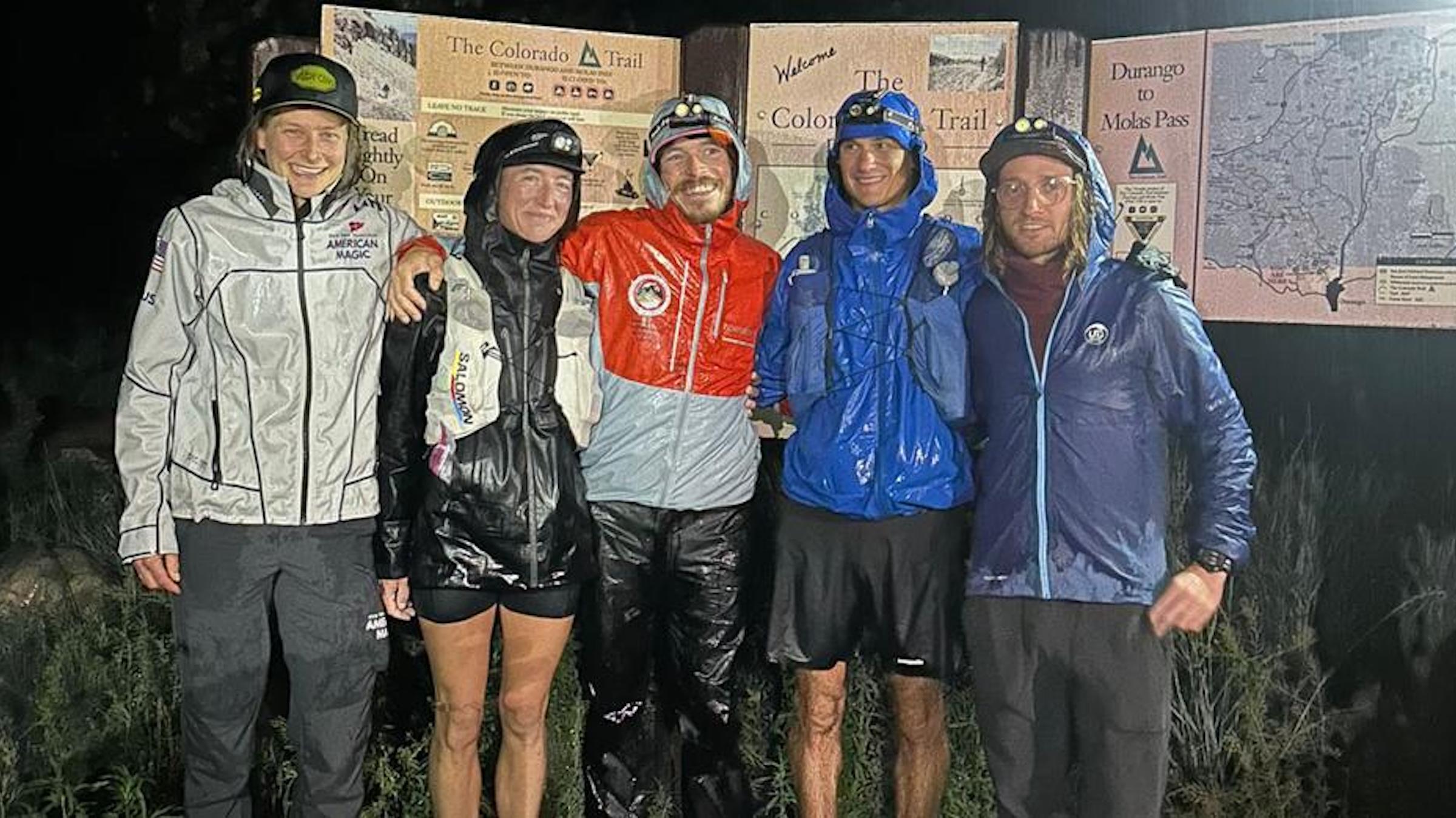 Curtin stands with his support team at the terminus of the Colorado Trail at night.
