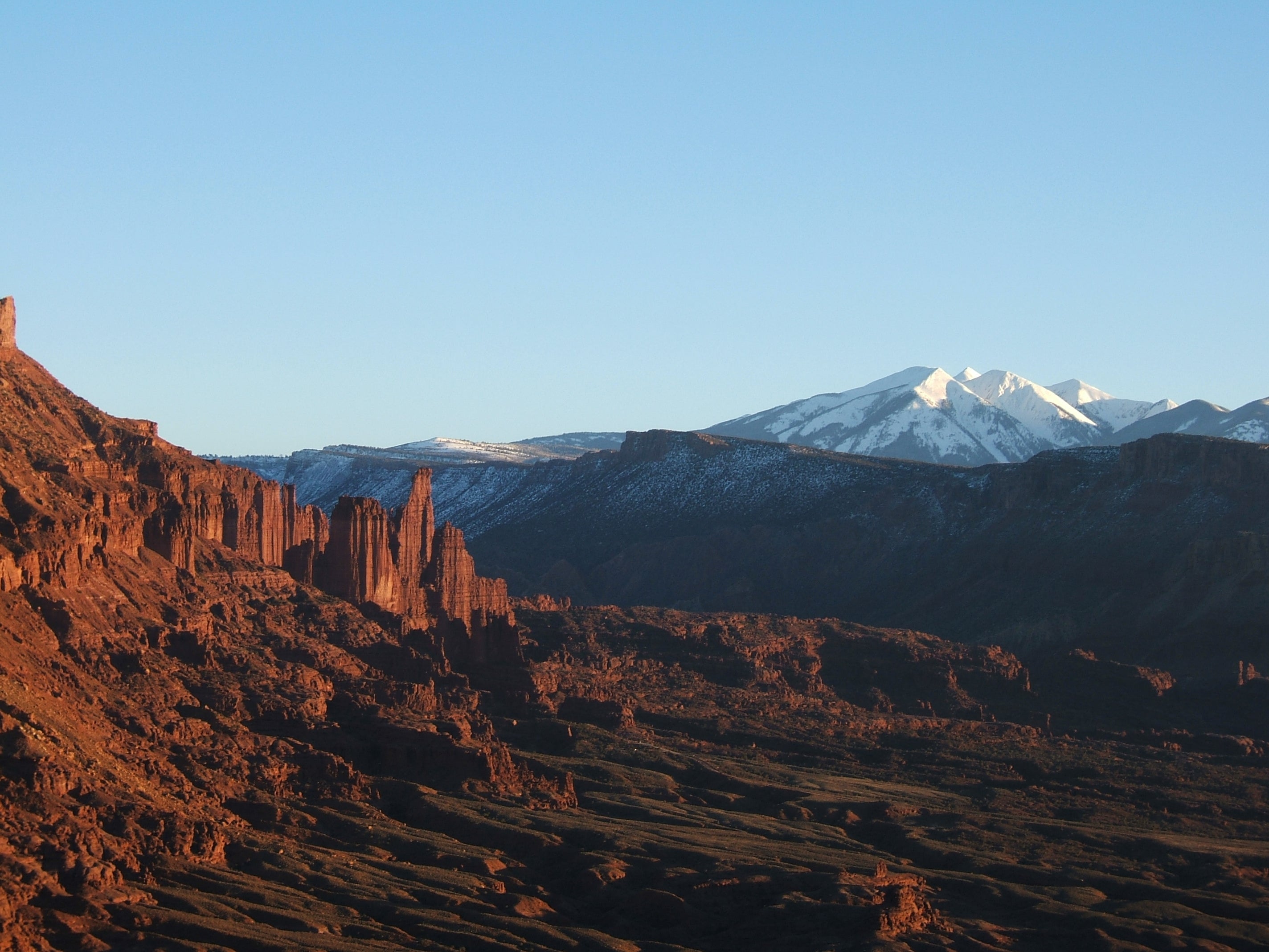 View of Fisher Towers area This shot was taken from a cliff we climbed across the Colorado River, about 5 crow miles away from Fisher Towers. It was just about sunset, and the…